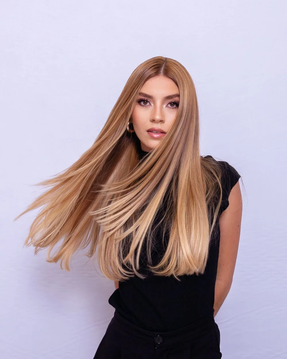 Woman with long honey-blonde hair; representative hairstyle image. Representative image, not a photograph of Honey Blonde Glueless Wig.